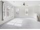 Expansive living room showcasing plush carpeting and abundant natural light through several large windows at 2421 Kudrow Ln, Morrisville, NC 27560