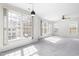 Spacious living room bathed in natural light from large windows, complemented by plush carpeting at 2421 Kudrow Ln, Morrisville, NC 27560