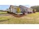 Relaxing backyard patio area features seating and beautiful landscaping at 25 Cornfield Ln, Benson, NC 27504