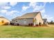 Lush backyard featuring a well-manicured lawn, a patio with seating, and manicured landscaping at 25 Cornfield Ln, Benson, NC 27504