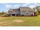 Spacious backyard featuring a well-maintained lawn, patio area, and landscaped borders at 25 Cornfield Ln, Benson, NC 27504