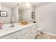 Bright bathroom featuring dual vanities with white cabinets, a large mirror, and a separate shower at 25 Cornfield Ln, Benson, NC 27504