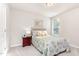 Bright bedroom featuring a tufted headboard, natural light, and a classic accent mirror at 25 Cornfield Ln, Benson, NC 27504