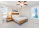 Comfortable bedroom featuring a rustic wooden bed frame, soft neutral bedding, and natural light from a window at 25 Cornfield Ln, Benson, NC 27504