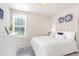 Cozy bedroom with a decorative white iron bed frame, white comforter, and bright natural light at 25 Cornfield Ln, Benson, NC 27504