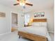 Cozy bedroom features natural wood furniture, soft lighting, and a view into the primary bathroom at 25 Cornfield Ln, Benson, NC 27504