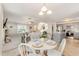 Bright dining area featuring a white round table, four chairs, and an open-concept view to the living room and kitchen at 25 Cornfield Ln, Benson, NC 27504