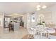 Dining area showcasing a white round table with a kitchen view boasting gray cabinets, stainless steel appliances, and an island at 25 Cornfield Ln, Benson, NC 27504