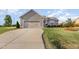 Beautiful home featuring manicured lawn, lovely landscaping, and a large driveway for easy access at 25 Cornfield Ln, Benson, NC 27504