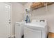 Functional laundry room with a washer, dryer, wire shelving, and convenient access to the outdoors at 25 Cornfield Ln, Benson, NC 27504