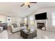 Bright, open living room featuring vaulted ceilings, neutral decor, and fireplace at 25 Cornfield Ln, Benson, NC 27504