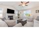 Bright, open living room featuring vaulted ceilings, neutral decor, fireplace, and large windows at 25 Cornfield Ln, Benson, NC 27504