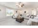 Comfortable living room with ample seating, neutral colors, a ceiling fan, and lots of natural light at 25 Cornfield Ln, Benson, NC 27504
