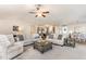 Open-concept living room with comfortable seating, neutral tones, and a seamless flow to the kitchen and dining area at 25 Cornfield Ln, Benson, NC 27504