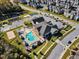 Aerial view of a community pool and amenities with parking and nearby apartments at 2528 Forge Village Way, Apex, NC 27523