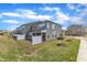 Exterior view of townhomes with a grassy backyard and white privacy fence at 2528 Forge Village Way, Apex, NC 27523