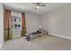 Spacious bedroom with large window, ceiling fan, and workout equipment at 2528 Forge Village Way, Apex, NC 27523