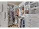 Well-organized walk-in closet featuring custom shelves and ample hanging space at 2528 Forge Village Way, Apex, NC 27523