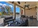 Covered patio with tile floors, ceiling fans, ample seating and pool view at 2528 Forge Village Way, Apex, NC 27523