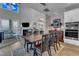 Open-concept dining room next to a living room with a fireplace and tv at 2528 Forge Village Way, Apex, NC 27523