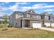 Charming two-story home with a two-car garage, well-kept lawn, and inviting curb appeal at 2528 Forge Village Way, Apex, NC 27523
