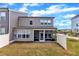 Back exterior view of the 2-story home with a screened-in porch and well-maintained lawn at 2528 Forge Village Way, Apex, NC 27523