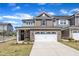 Inviting two-story home with brick accents, a two-car garage, and well-maintained landscaping at 2528 Forge Village Way, Apex, NC 27523