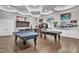 Game room with ping pong table, pool table, TVs and arcade games at 2528 Forge Village Way, Apex, NC 27523