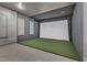 Golf simulator room with large screen, golf turf and padded gray walls at 2528 Forge Village Way, Apex, NC 27523