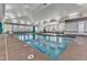 Bright indoor pool with multiple windows, lounge chairs and clear blue water at 2528 Forge Village Way, Apex, NC 27523