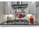 Close-up of the kitchen stove with sleek black countertop and stainless steel range hood at 2528 Forge Village Way, Apex, NC 27523
