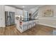 Well-lit kitchen showcasing a large island, stainless steel fridge, and modern finishes at 2528 Forge Village Way, Apex, NC 27523