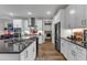 Modern kitchen with white cabinetry, stainless steel appliances, and ample counter space at 2528 Forge Village Way, Apex, NC 27523