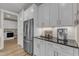 Kitchen with stainless steel refrigerator and countertop coffee station near the laundry room at 2528 Forge Village Way, Apex, NC 27523