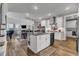 Open-concept kitchen with a center island, modern appliances, and ample cabinet space at 2528 Forge Village Way, Apex, NC 27523