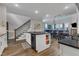 Spacious kitchen featuring a center island, hardwood floors, and views of the dining area at 2528 Forge Village Way, Apex, NC 27523