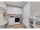 Bright laundry room with washer, dryer, storage cabinets, and utility sink at 2528 Forge Village Way, Apex, NC 27523