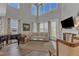 Bright, airy living room with high ceilings, many windows, and comfortable seating at 2528 Forge Village Way, Apex, NC 27523