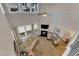 Aerial view of a sunny living room with fireplace, high ceilings, and lots of light at 2528 Forge Village Way, Apex, NC 27523