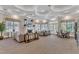 Spacious community lounge area with comfortable seating, fireplace, and decorative elements at 2528 Forge Village Way, Apex, NC 27523