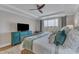 Comfortable main bedroom boasts neutral colors, ceiling fan, and flat screen television at 2528 Forge Village Way, Apex, NC 27523