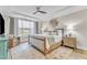 Comfortable main bedroom with ceiling fan, sitting area, and soft natural light at 2528 Forge Village Way, Apex, NC 27523