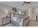 Comfortable main bedroom boasts trey ceiling, neutral color palette, area rug and a ceiling fan at 2528 Forge Village Way, Apex, NC 27523