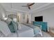 Comfortable main bedroom boasts neutral colors, ceiling fan, and flat screen television at 2528 Forge Village Way, Apex, NC 27523