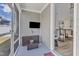 Cozy screened patio has a TV, wicker furniture, and access to the home's interior at 2528 Forge Village Way, Apex, NC 27523