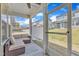 Relaxing screened-in porch featuring a comfortable outdoor seating area at 2528 Forge Village Way, Apex, NC 27523