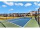 View of the community tennis courts, showcasing the well-maintained grounds and residential buildings at 2528 Forge Village Way, Apex, NC 27523