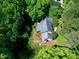 An aerial view of the house surrounded by lush trees, gray roof, and well-kept lawn at 2901 Hunters Bluff Dr, Raleigh, NC 27606
