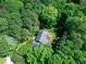 An aerial view of the house surrounded by lush trees, gray roof, and well-kept lawn at 2901 Hunters Bluff Dr, Raleigh, NC 27606
