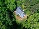 An aerial view of the house surrounded by lush trees, gray roof, and well-kept lawn at 2901 Hunters Bluff Dr, Raleigh, NC 27606